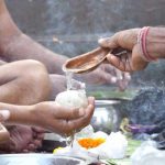 Men offering Tarpan during Pitru Paksha Rituals marking bhadra month