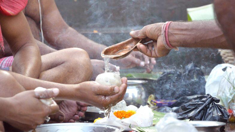 Men offering Tarpan during Pitru Paksha Rituals marking bhadra month