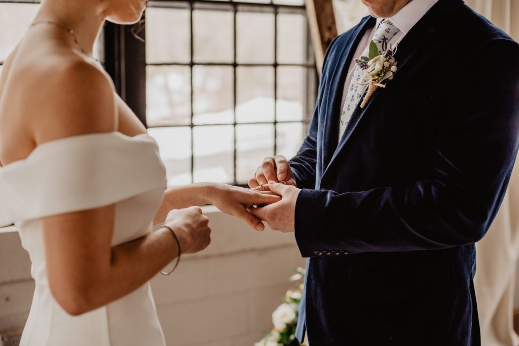 A Groom Putting a Wedding Ring On Bride's Finger