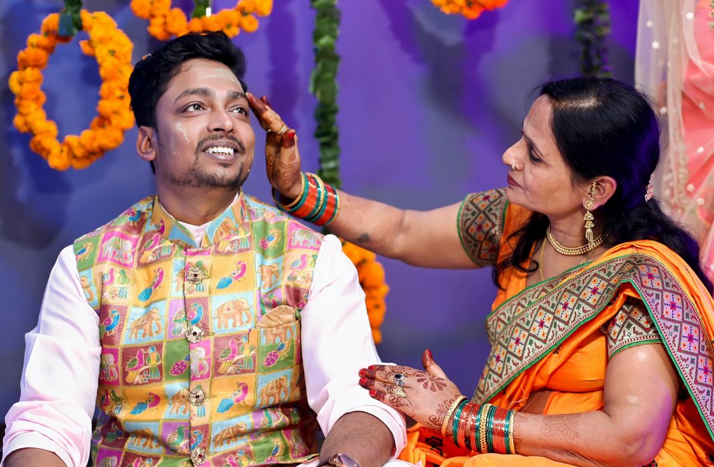Haldi being applied to Odia groom